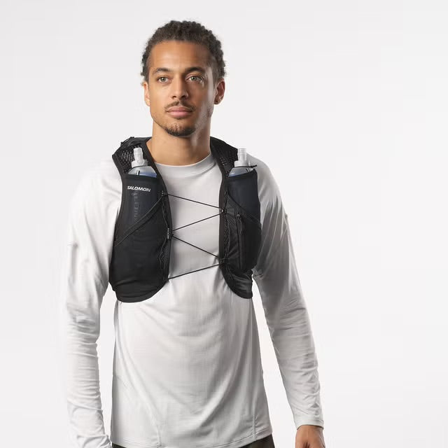 Person wearing a Salomon hydration vest on a plain background