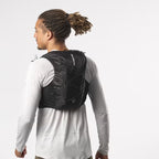 Person wearing a black running vest on a white background