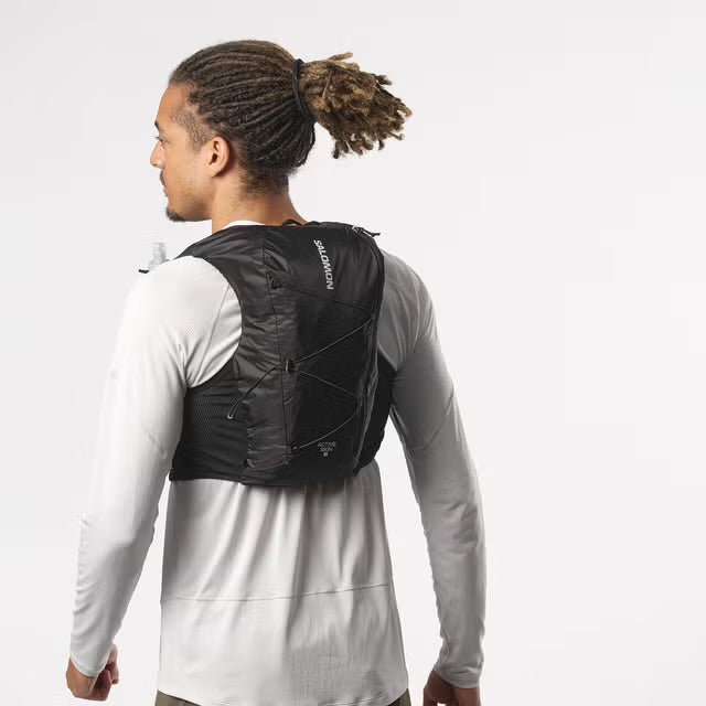 Person wearing a black running vest on a white background